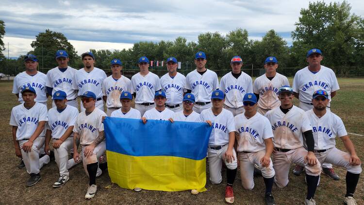 Ukrainian National Baseball Team posing with the country's flag.