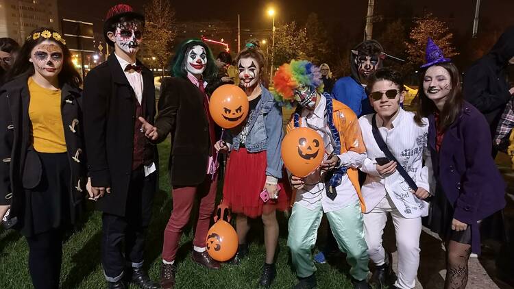 A group of teenagers or young adults dressed up in Halloween costumes.