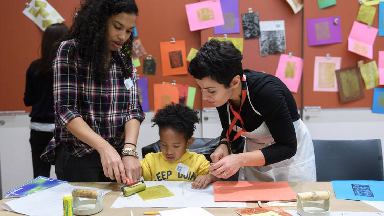 A young child makes a craft as part of World Culture Festival.