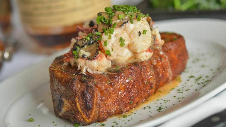 A steak topped with crab meat.