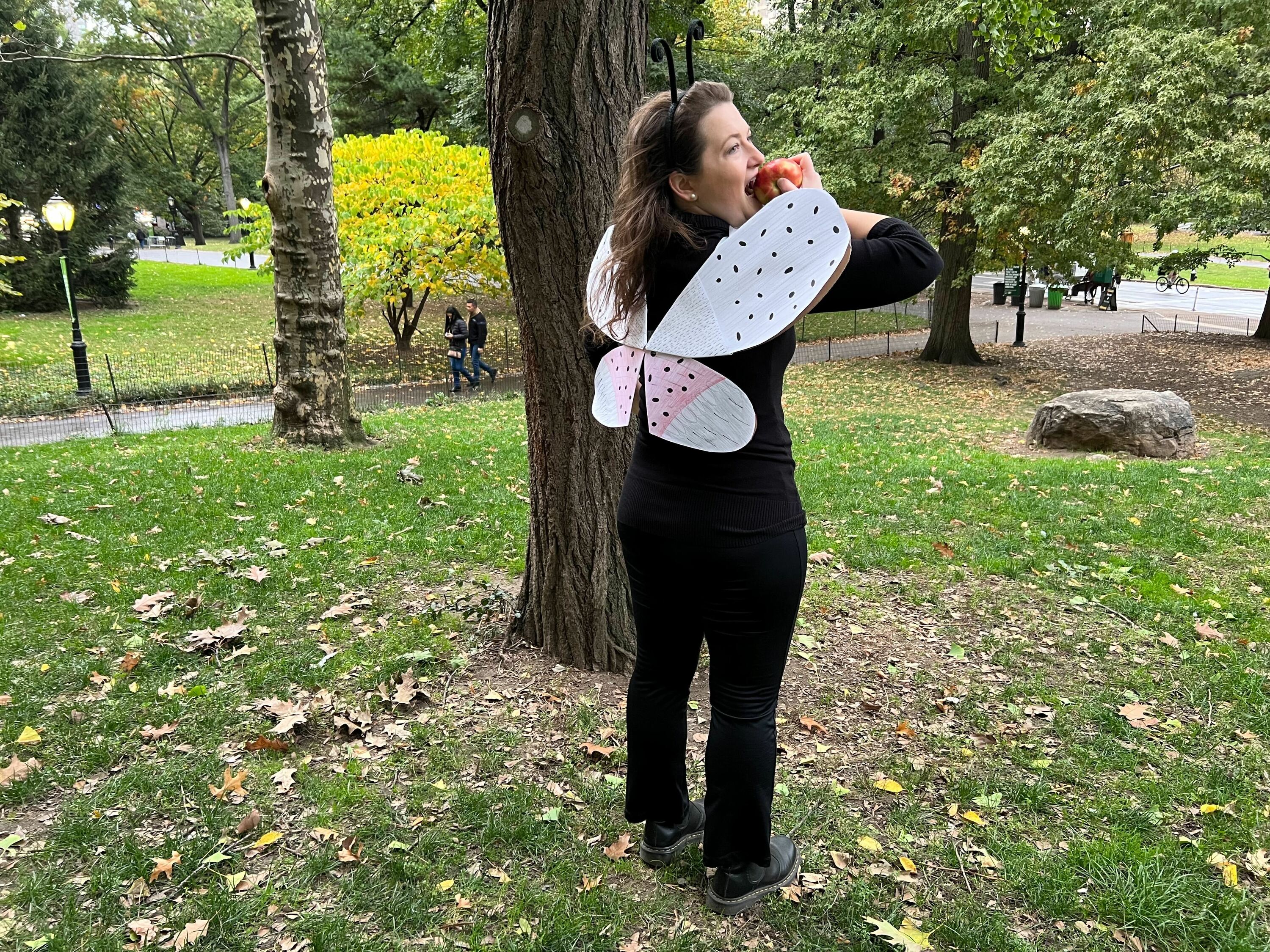 A woman dressed up as a spotted lanternfly.