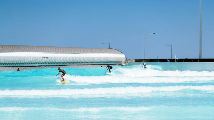 Surfers are riding waves at Urbnsurf