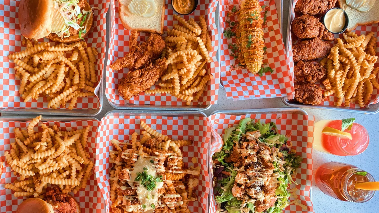 A variety of fried chicken platters spread out.