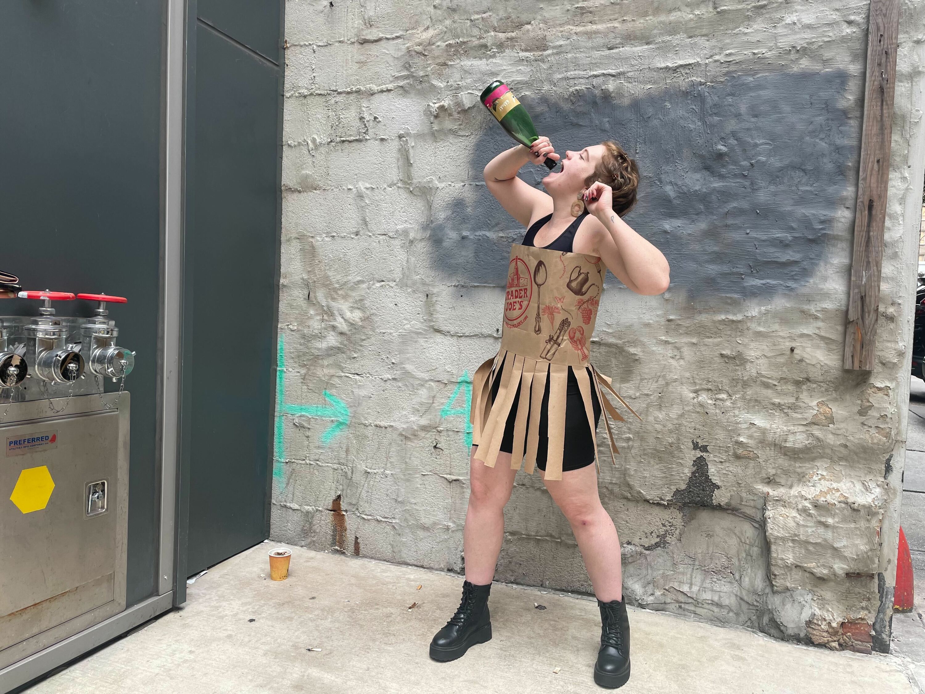 A woman wears a dress made out of Trader Joe's bags.