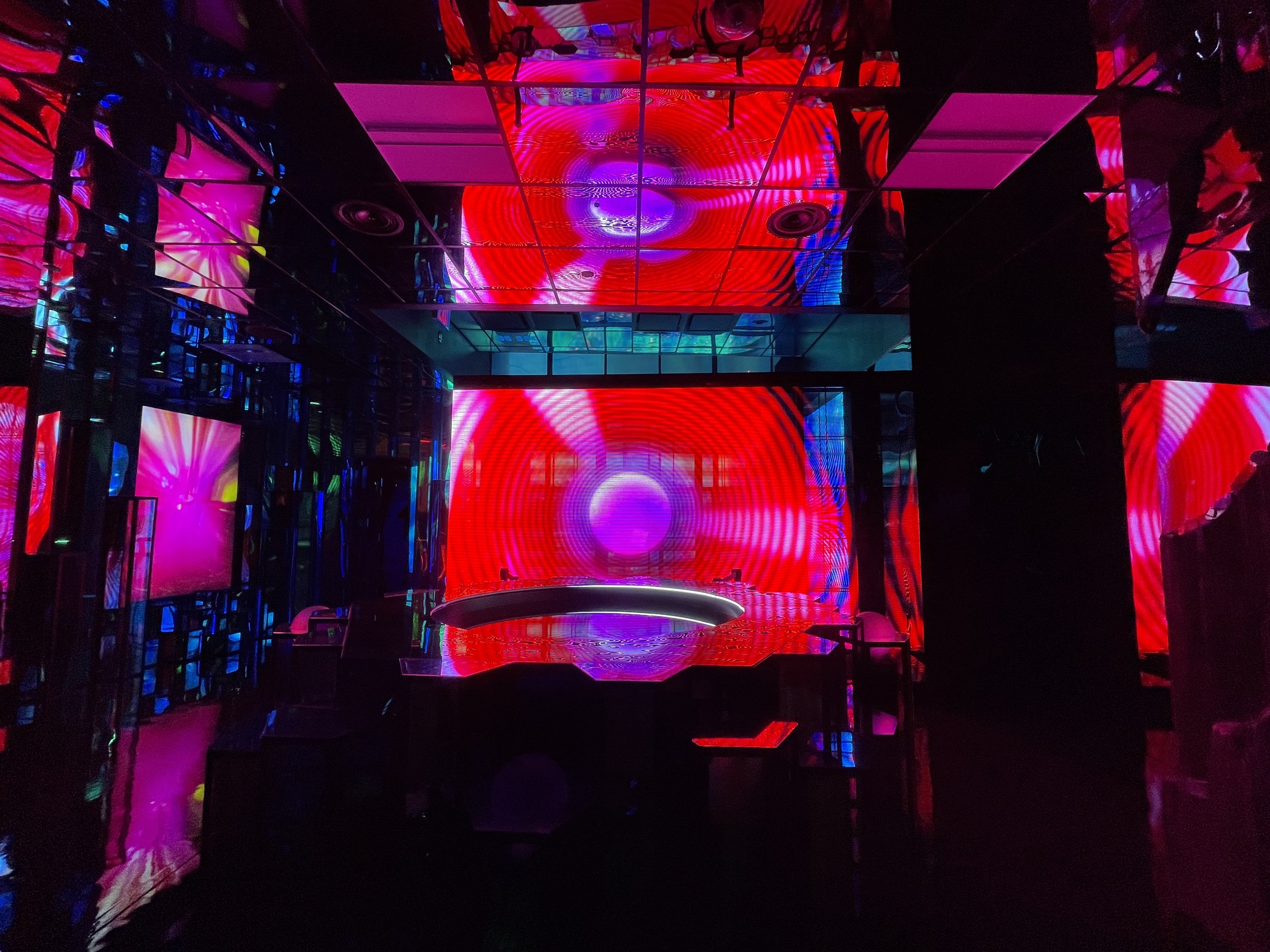 A water installation in INTER with red and purple lighting.