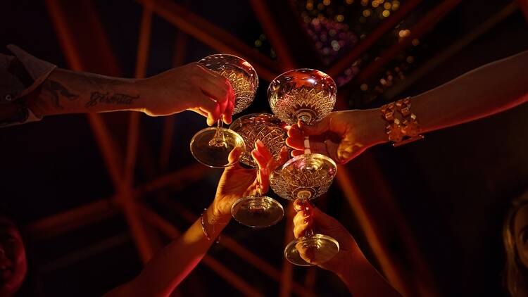 Four glasses of bubbles under the fireworks at the Sydney Opera House