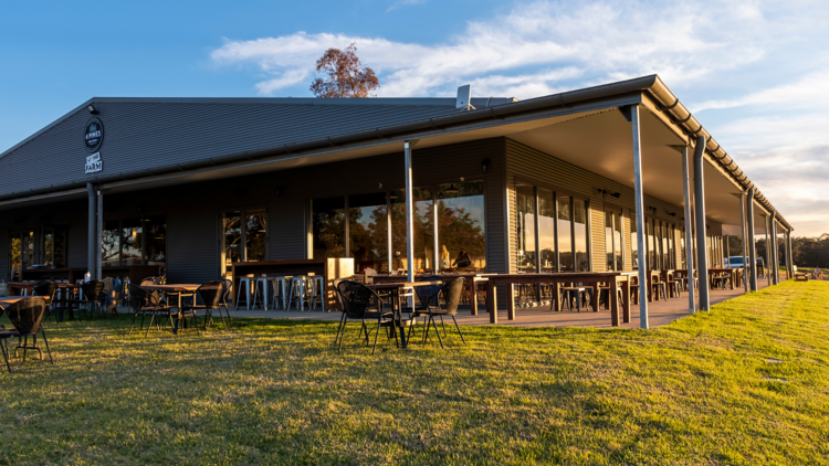 The outside facade of the Four Pines venue on a hill