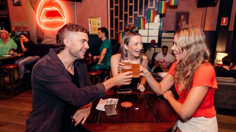Three punters are enjoying a beer at a pub