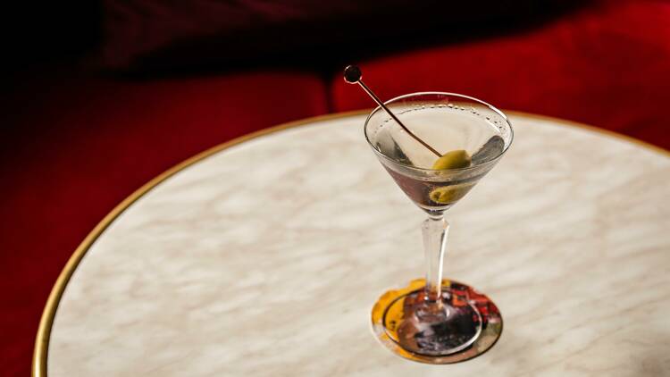 A Martini with one green olive