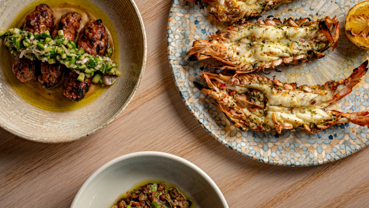 Flat lay of prawns, pomegranate and chorizo