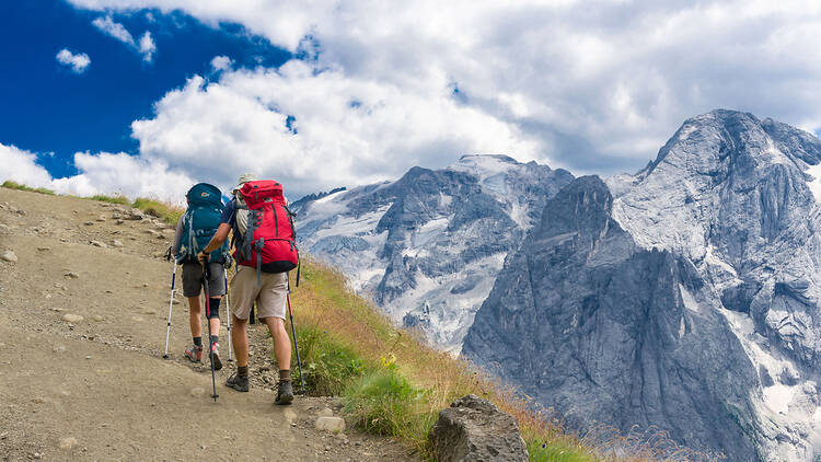 Hikers near glaciers in the Dolomite mountains