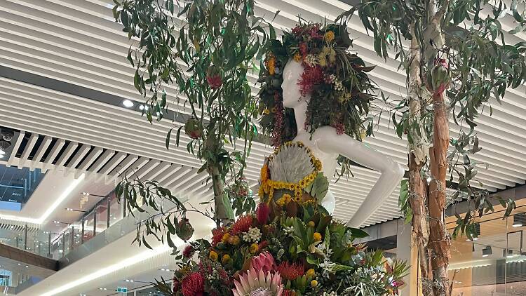 A life-sized mannequin decked out in a floral dress.