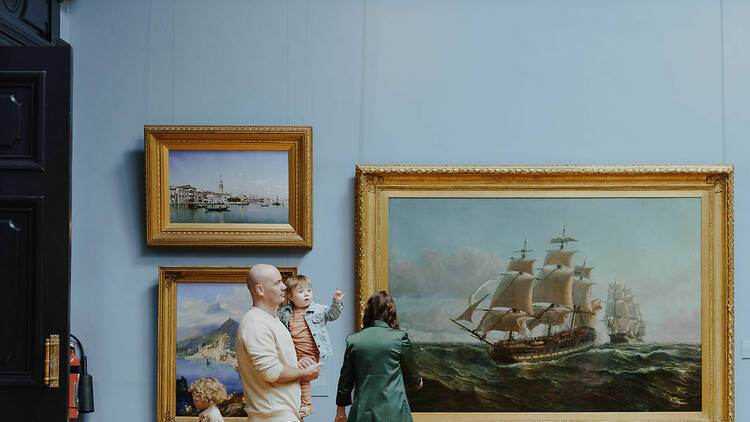 A family wandering through a pirate-themed exhibition.