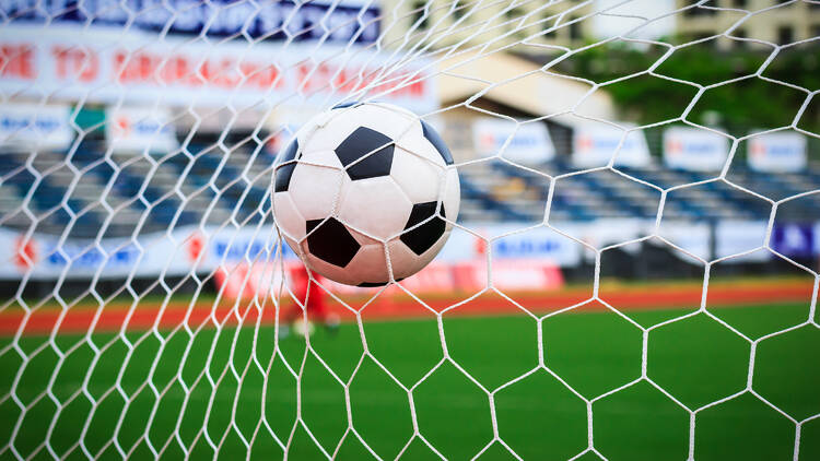 soccer ball in goal net