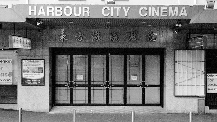 A black and white photo of the outside of Harbour City Cinema