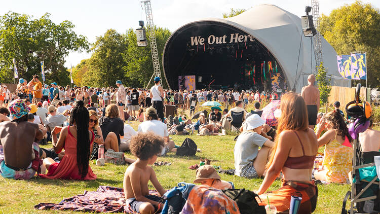 People sitting down at a festival 