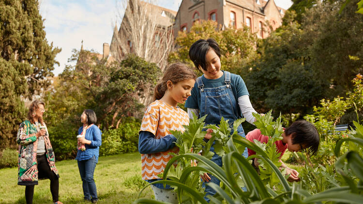 A group of children and parents hanging out at Abbotsford Convent.