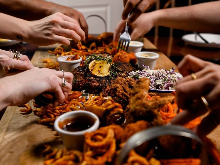 A platter of bar food being devoured