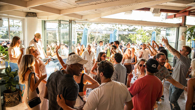 A group of people are dancing and having fun at Coogee Pavilion