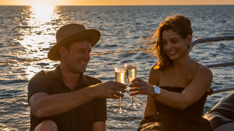 Drink champagne and eat oysters on a sunset harbour cruise