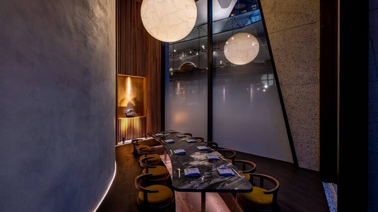 A private dining room at Oborozuki with a statement round light and elegant furnishings 