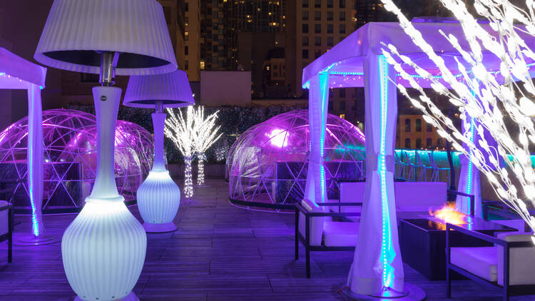 The lit-up rooftop patio at the I|O Godfrey