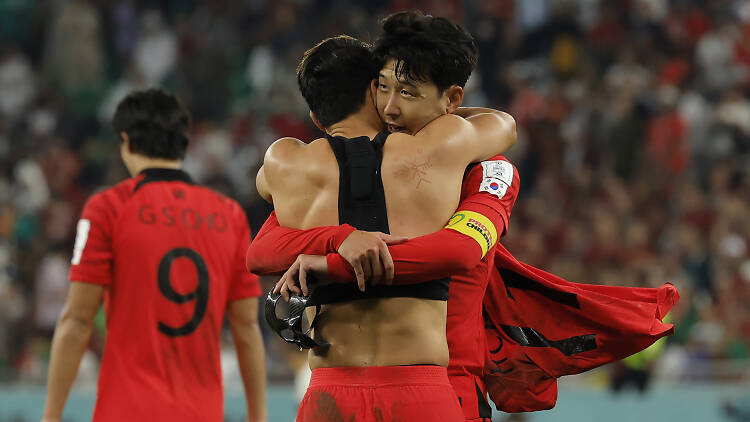South Korea's midfielder #11 Hwang Hee-chan (C) celebrates with South Korea's midfielder #07 Son Heung-min after scoring his team's second goal during the Qatar 2022 World Cup Group H football match between South Korea and Portugal 