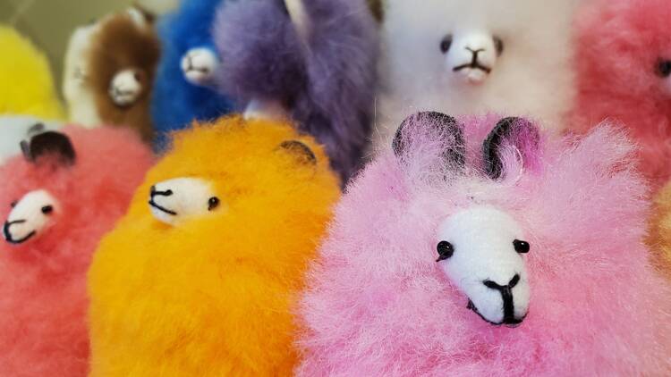 Toy alpacas in multiple bright colors at the Fair Trade Holiday Pop-Up