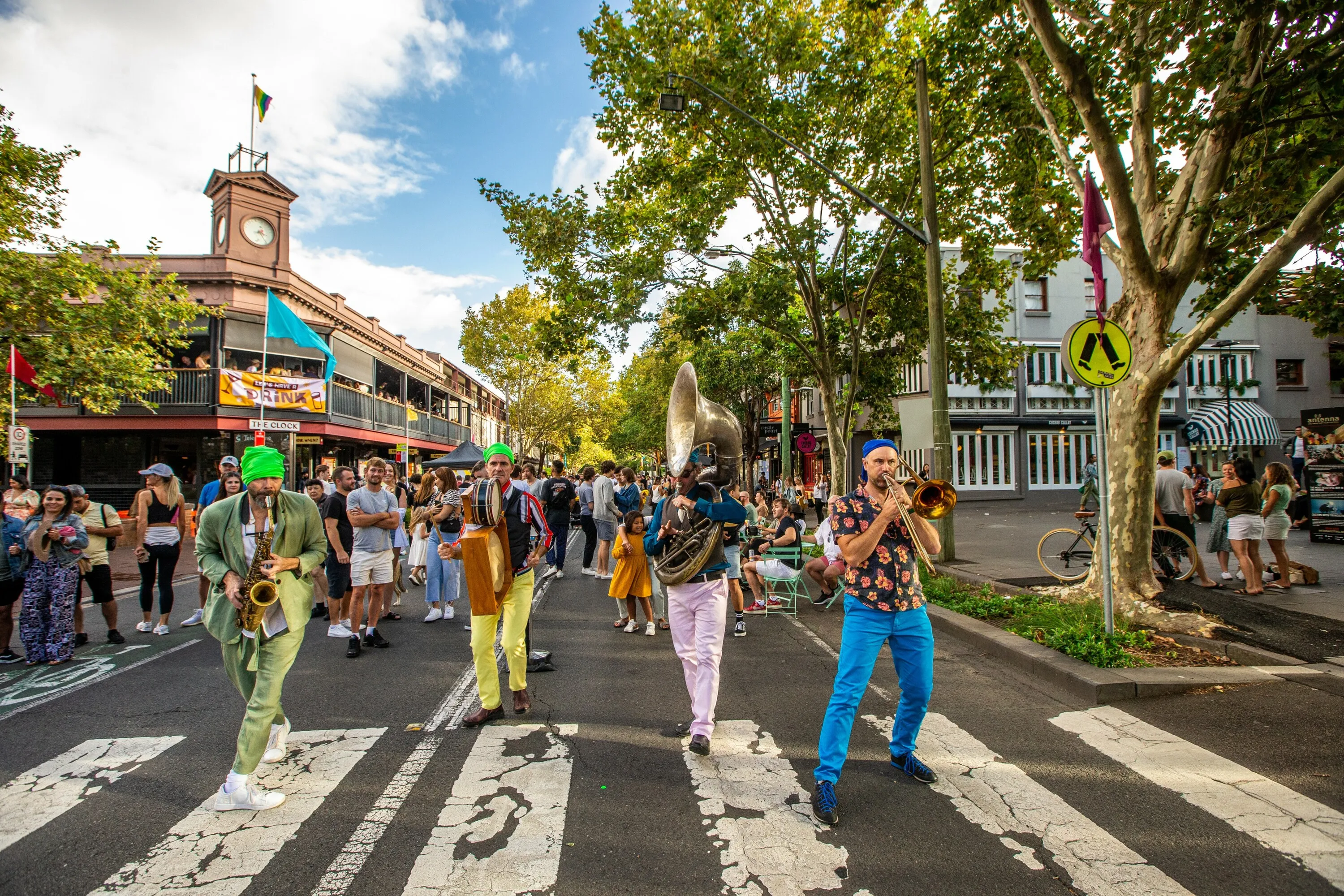 A band plays as people walk along Crown Street in Surry Hills