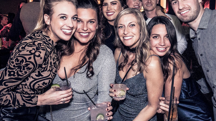 People pose for a photo during a New Year's Eve party at Fremont