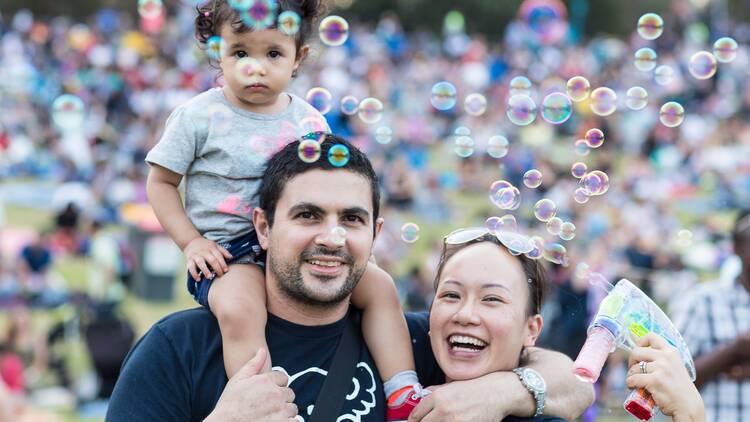 A young family at an event with bubbles
