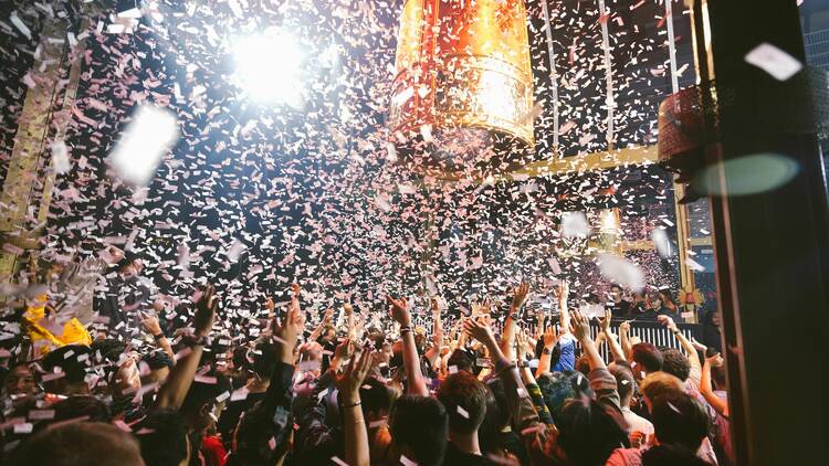 People dance as a confetti cannon goes off at TAO Chicago