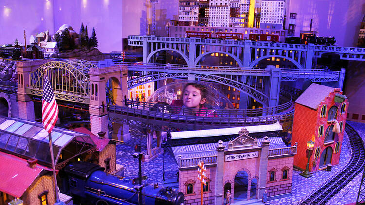 A child looks at model trains.