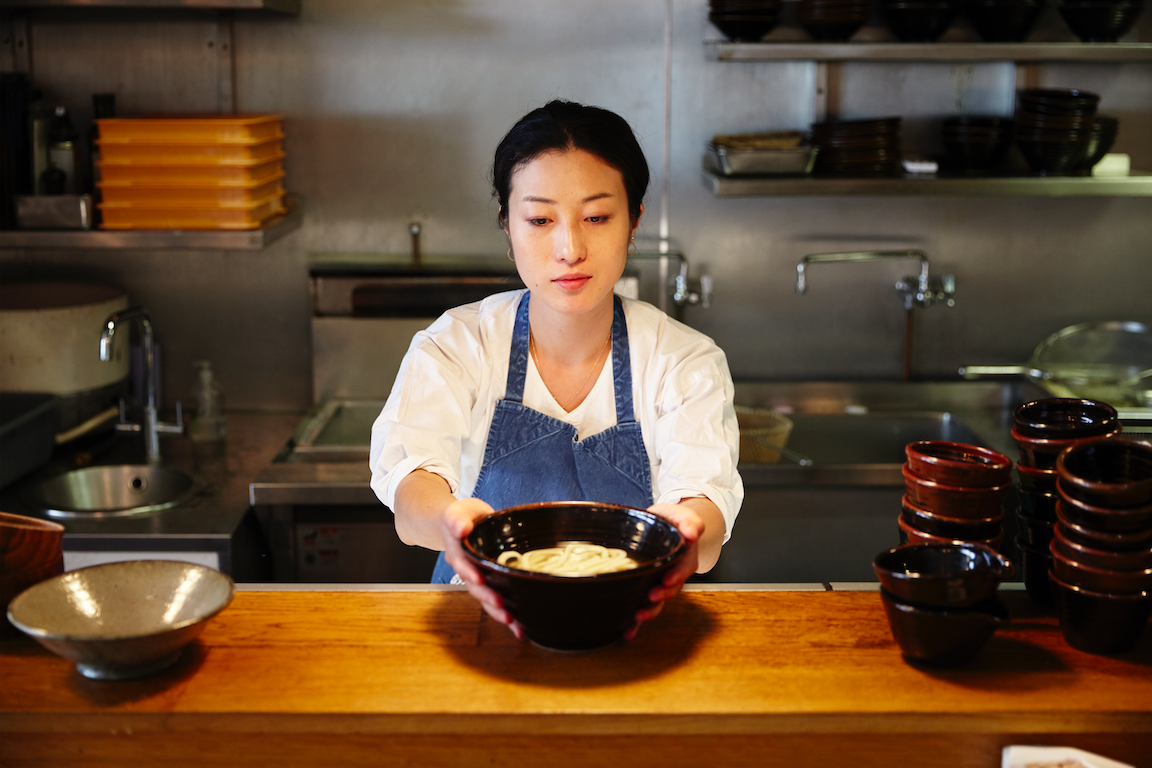 Shuko Oda holding udon at her restaurant Koya in London