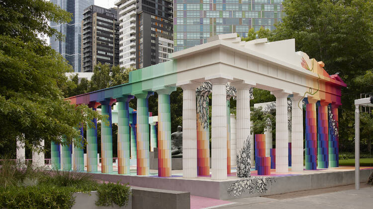 An ancient Greek-style temple with coloured columns in the NGV garden.