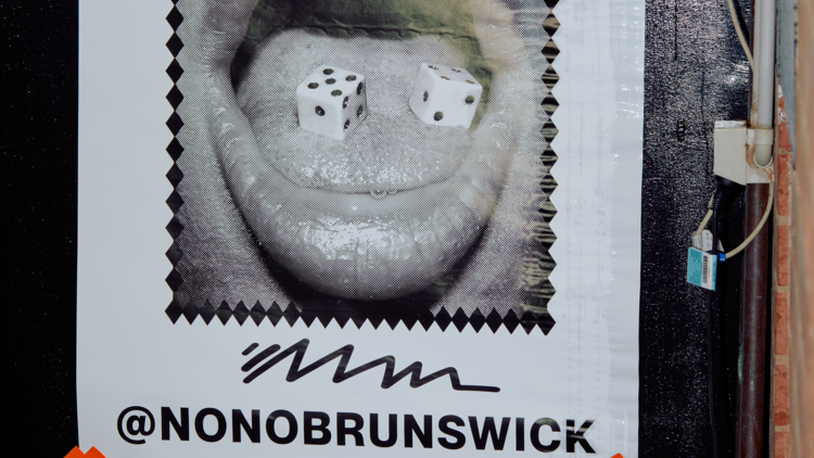 There is a poster with a mouth open and the words "nonobrunswick" under it