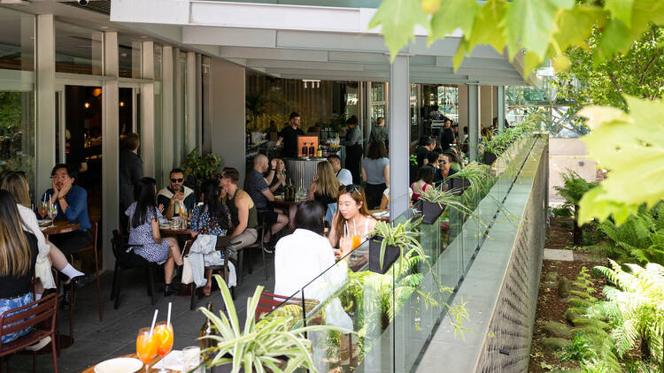 Guests are outside on Victoria's sunnt terrace enjoying a seven-course menu and cocktials