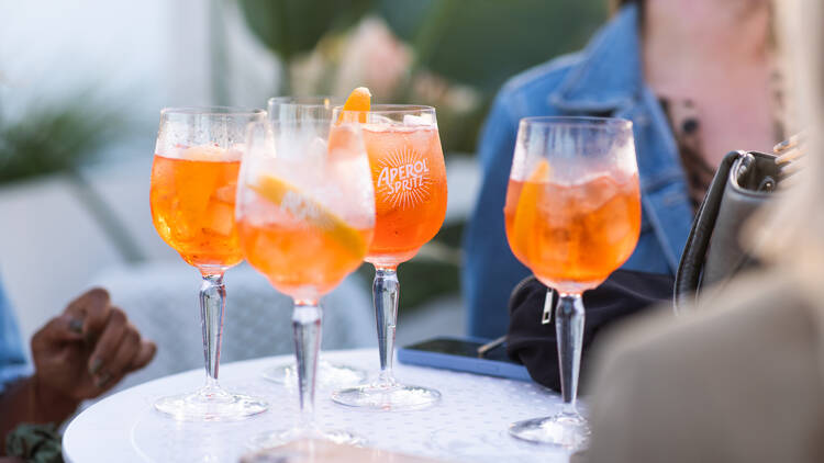 Four glasses of Aperol Spritz