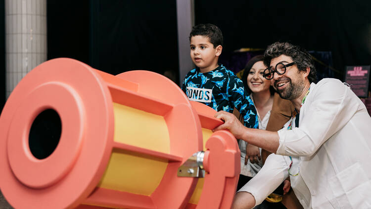 A family launching a play cannon at Chaos Lab.