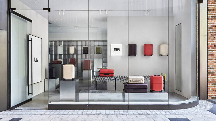 A glass-walled shop for July, a luggage company.