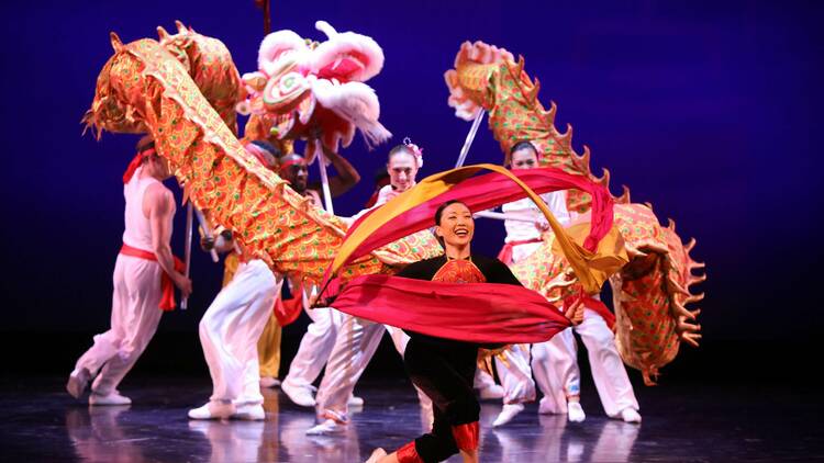 Dancers perform with a dragon puppet.