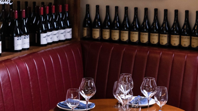 A table set with plates and wine glasses.