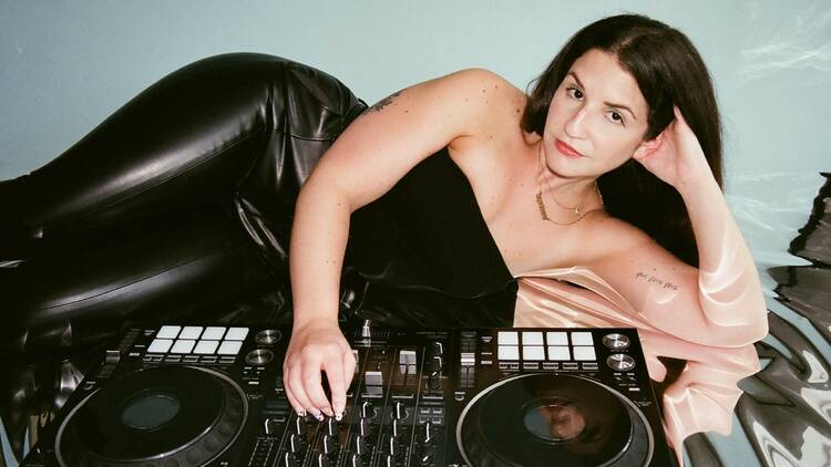 Ilana Michelle Rubin poses for a picture next to a turntable.