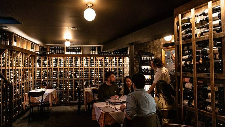 Downstairs of Pellegrino 2000 with hundreds of wine bottles on the walls