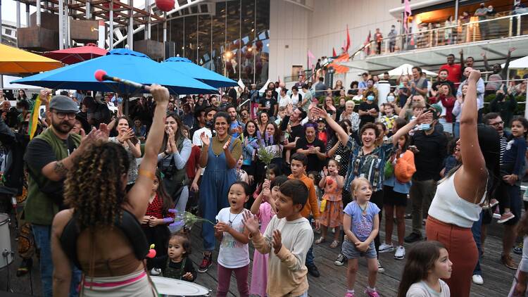 A crowd watching performers and cheering.