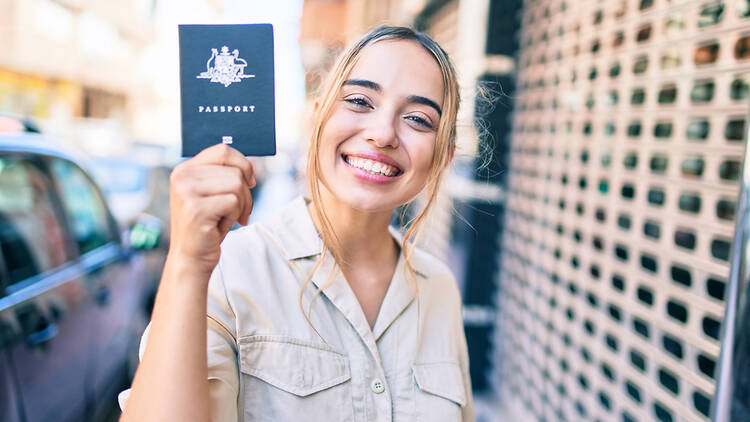 A woman holding an Australian passport