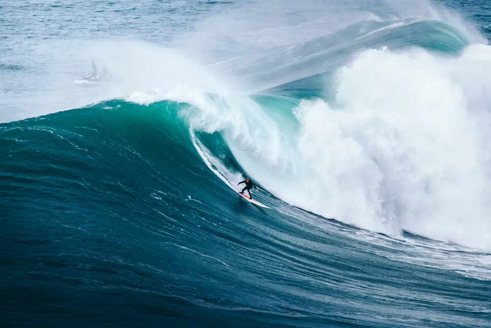Surfing big waves in Nazare Portugal