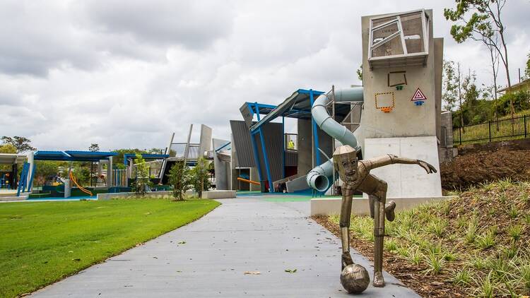 A modern playground with a statue of a robot