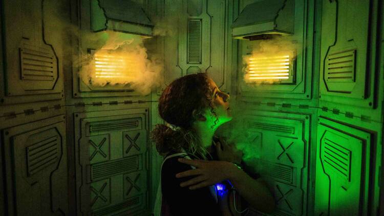 A woman in a steam room, as part of an Among Us-themed game.