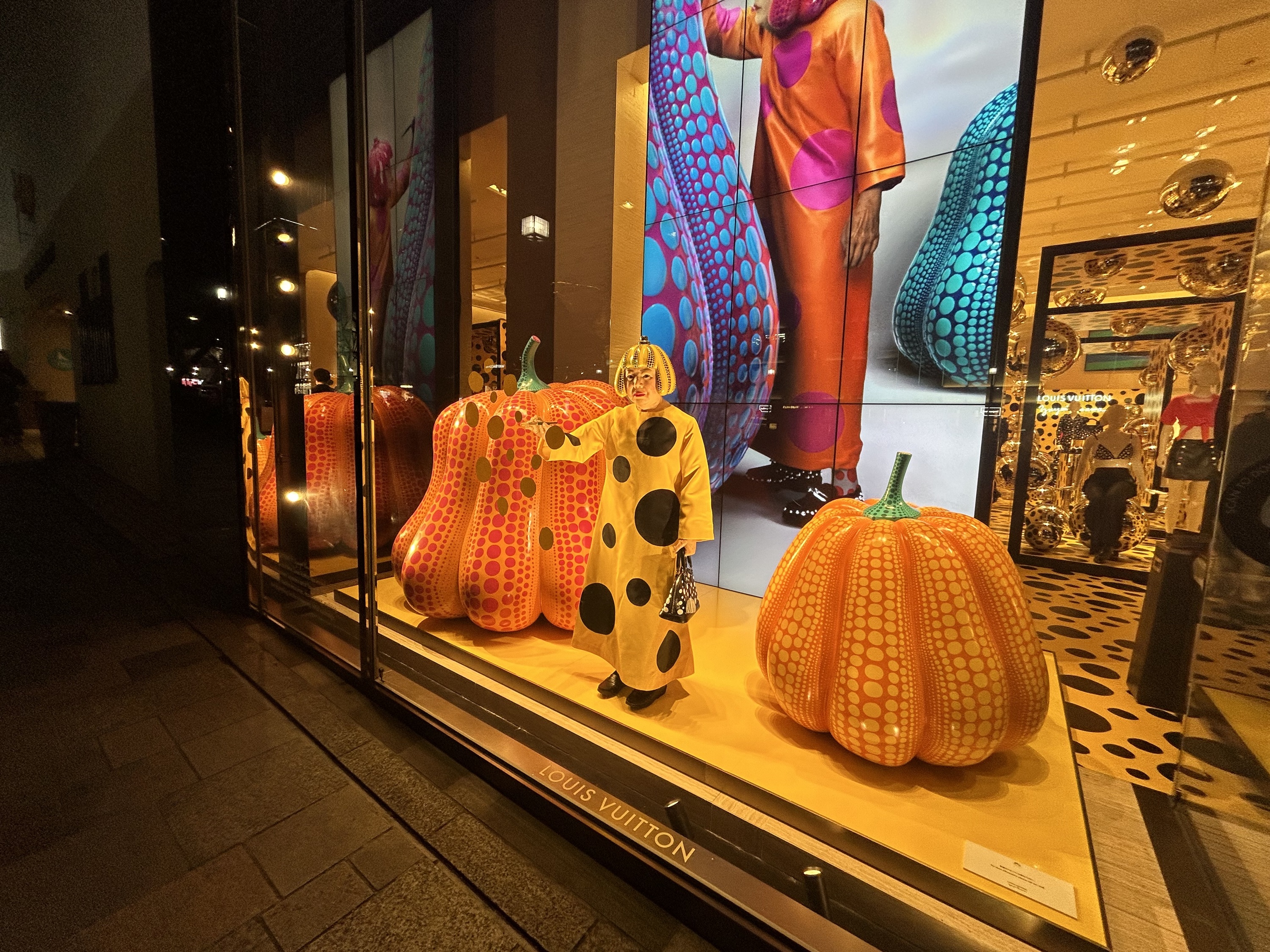 Robot of artist Yayoi Kusama in window of NY Louis Vuitton store